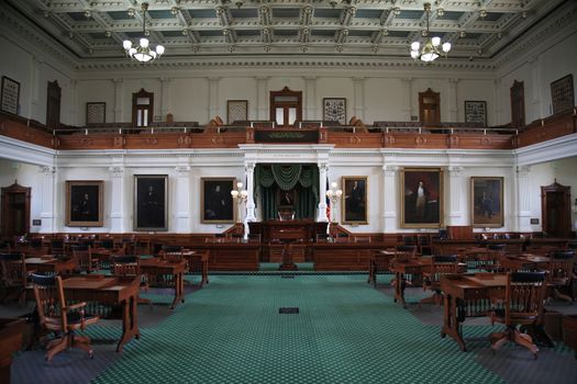 Desks and chairs in the historic senate chamber located in the Texas capital building in Austin.