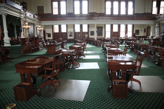 Desks and chairs in the historic senate chamber located in the Texas capital building in Austin.