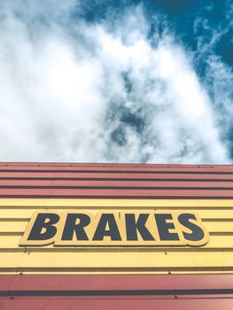 An Auto Repair Shop Or Garage With Gaudy Brakes Sign
