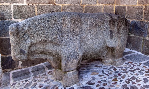 Ancient Stone Bull Statue Avila Castile Spain.  Bull statue was from 200BC and is called Verraco.  Avila is described as the most 16th century town in Spain.  