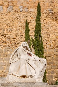 White Saint Teresa Statue Walls Castle Avila Castile Spain.  Avila described as the most 16th century town in Spain.  Saint Teresa Statue created 1972 by Juan Luis Vassallo. Walls created in 1088 after Christians conquer  Moors  