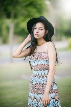 Beautiful girl is posing in vintage suit with black hat.