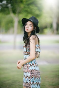 Beautiful girl is posing in vintage suit with black hat.