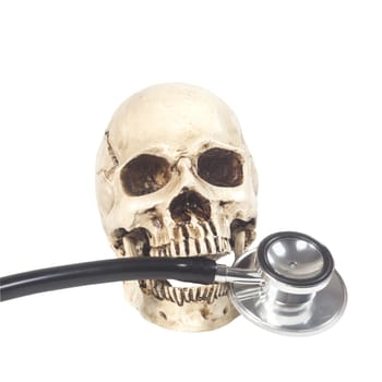 human skull and stethoscope on white background