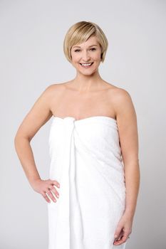 Smiling middle aged woman in towel after shower