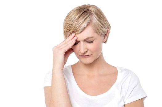 Worried woman holding her head, migraine