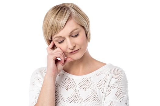 Thoughtful woman posing over white background