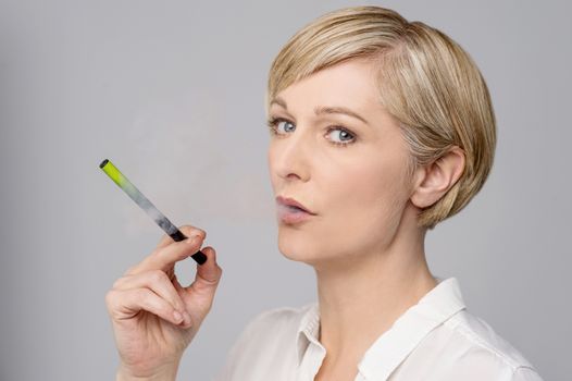 Image of a modern woman smoking e-cigarette