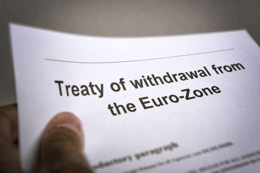 Man holding an treaty on the withdrawal from the euro zone in the hand