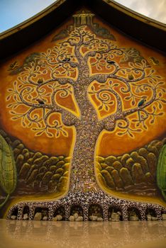 Art tree glow on the back of the hall of the temple in Thailand.
