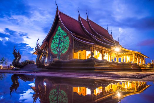 Art tree glow on the back of the hall of the temple in Thailand.