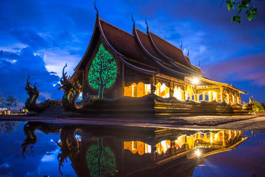 Art tree glow on the back of the hall of the temple in Thailand.