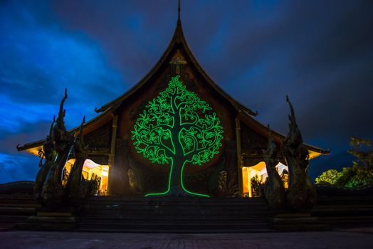 Art tree glow on the back of the hall of the temple in Thailand.