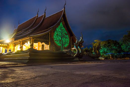 Art tree glow on the back of the hall of the temple in Thailand.