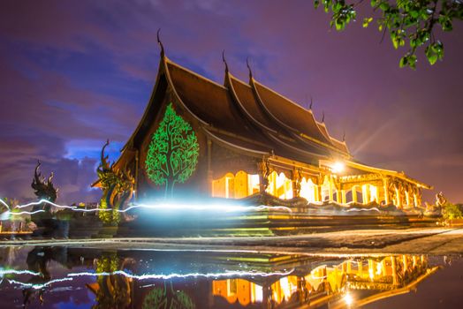 Art tree glow on the back of the hall of the temple in Thailand.