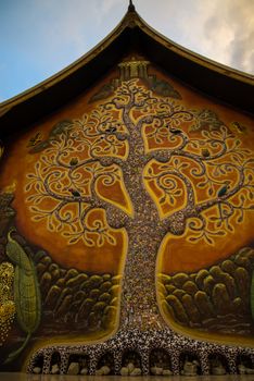 Art tree glow on the back of the hall of the temple in Thailand.