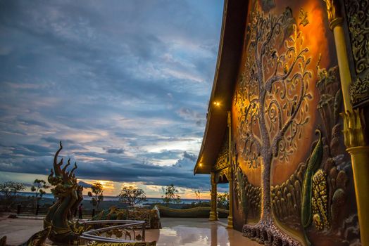 Art tree glow on the back of the hall of the temple in Thailand.