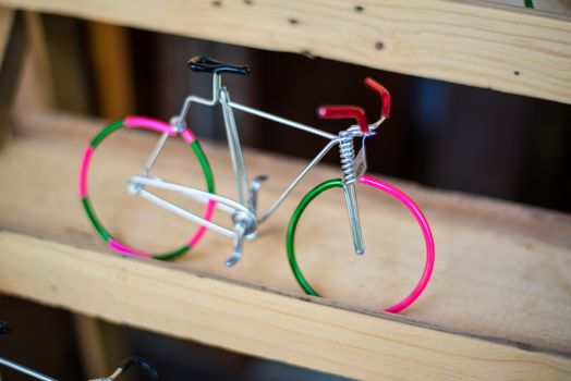 Miniature Bicycle  made of wire.Placed on wooden racks