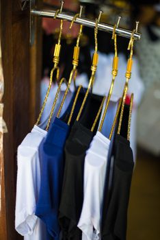 T-shirts hanging on a clothesline in a clothing store.