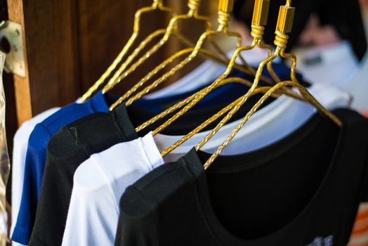 T-shirts hanging on a clothesline in a clothing store.