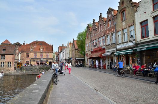 Bruges, Belgium - May 11, 2015: Tourist visit Rozenhoedkaai (The Quai of the Rosary) in Bruges, Belgium. Bruges is the capital and largest city of the province of West Flanders in the Flemish Region of Belgium. 