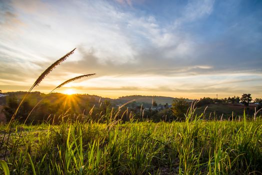 Sunrise in the morning, surrounded by mountains and meadows.
