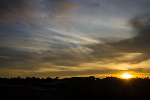 Sunrise in the morning, surrounded by mountains and meadows.