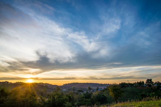 Sunrise in the morning, surrounded by mountains and meadows.