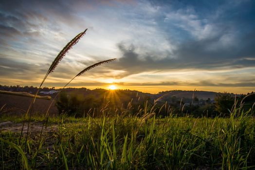 Sunrise in the morning, surrounded by mountains and meadows.