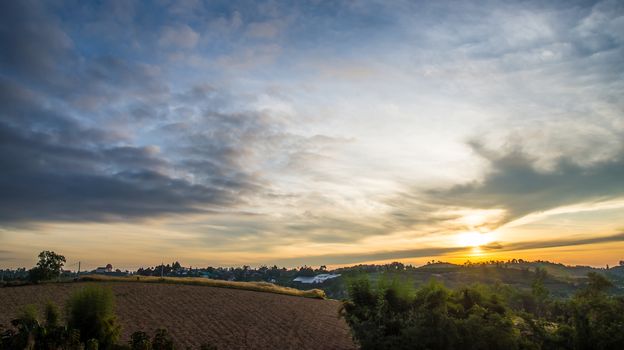 Sunrise in the morning, surrounded by mountains and meadows.
