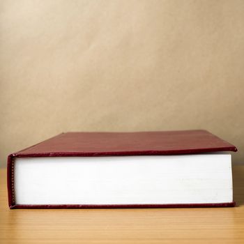 red book on wood table background