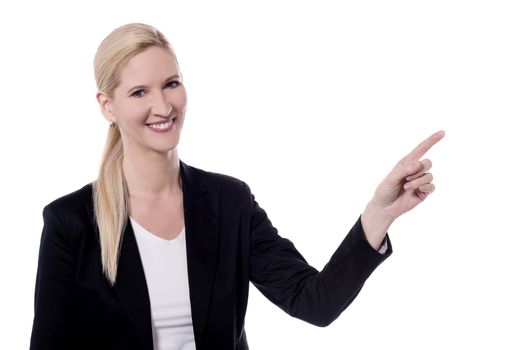 Business woman pointing at something over white