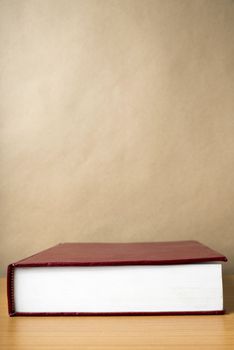 red book on wood table background