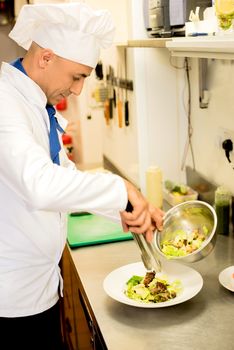 Delicatessen salad decorated by male chef