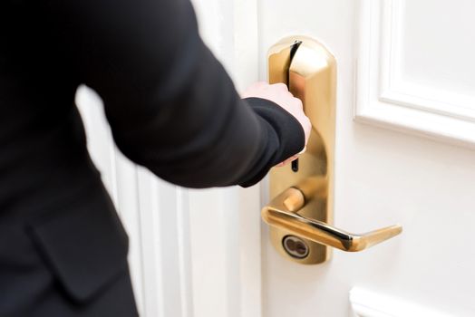 Woman hand inserting key card in electronic lock