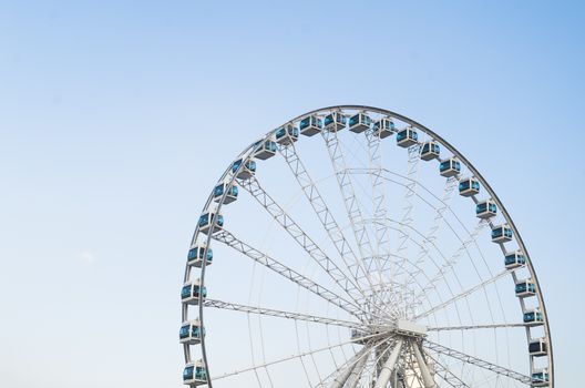 Ferris wheel over blue sky