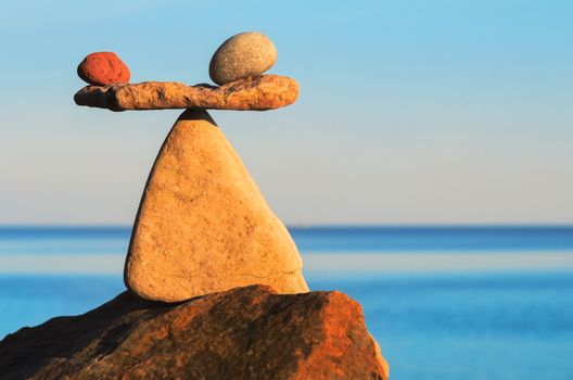 Two apples in balance on the top of stone