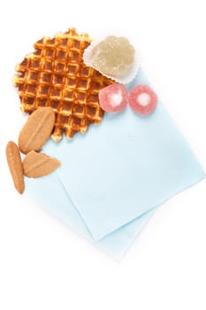 background biscuits, waffles, fruit jelly and fork and napkin isolated on white background