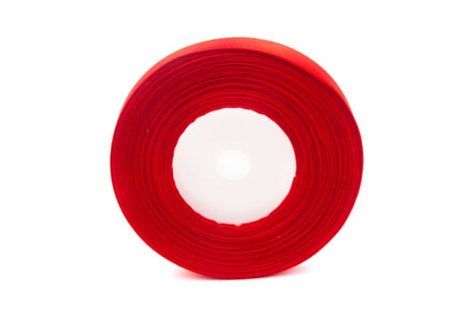 skein of red ribbon on white background