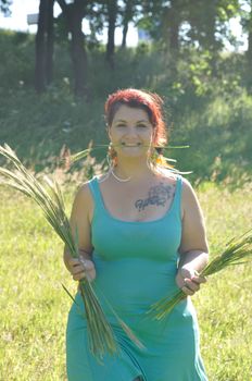 portrait of red  hair woman with strand of wheat