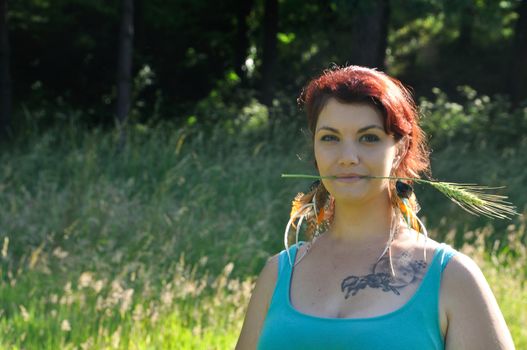 portrait of red  hair woman with strand of wheat