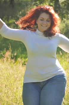 Woman running in a meadow 