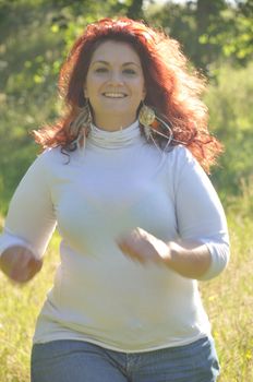 Woman running in a meadow 