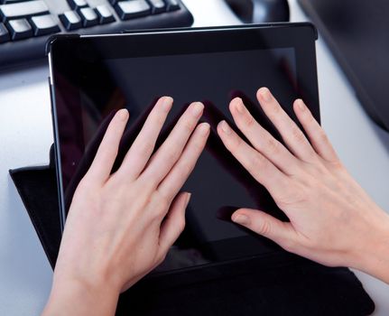 business woman in the workplace is working on a tablet