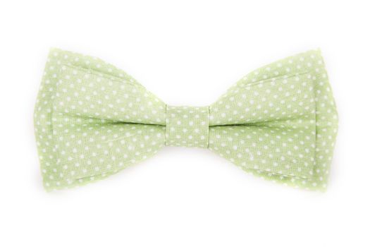 green bow tie with white polka dots on an isolated white background
