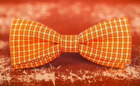 orange bow tie with white stripes