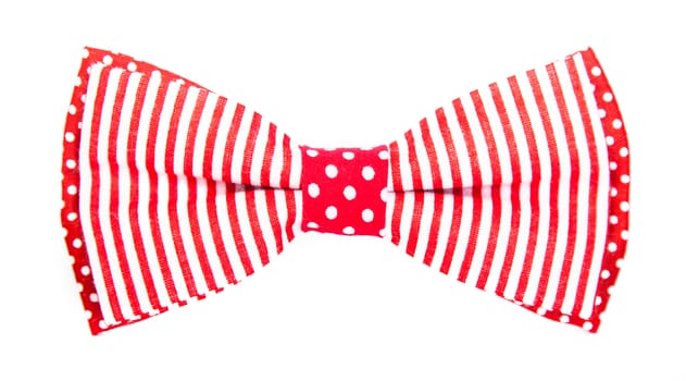 red bow tie with stripes and polka dots on an isolated white background