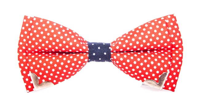 red bow tie with white polka dots on an isolated white background