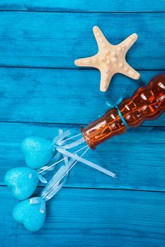 blue hearts in a vase and starfish on blue wooden background