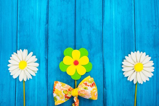 Floral composition with bow tie on blue background